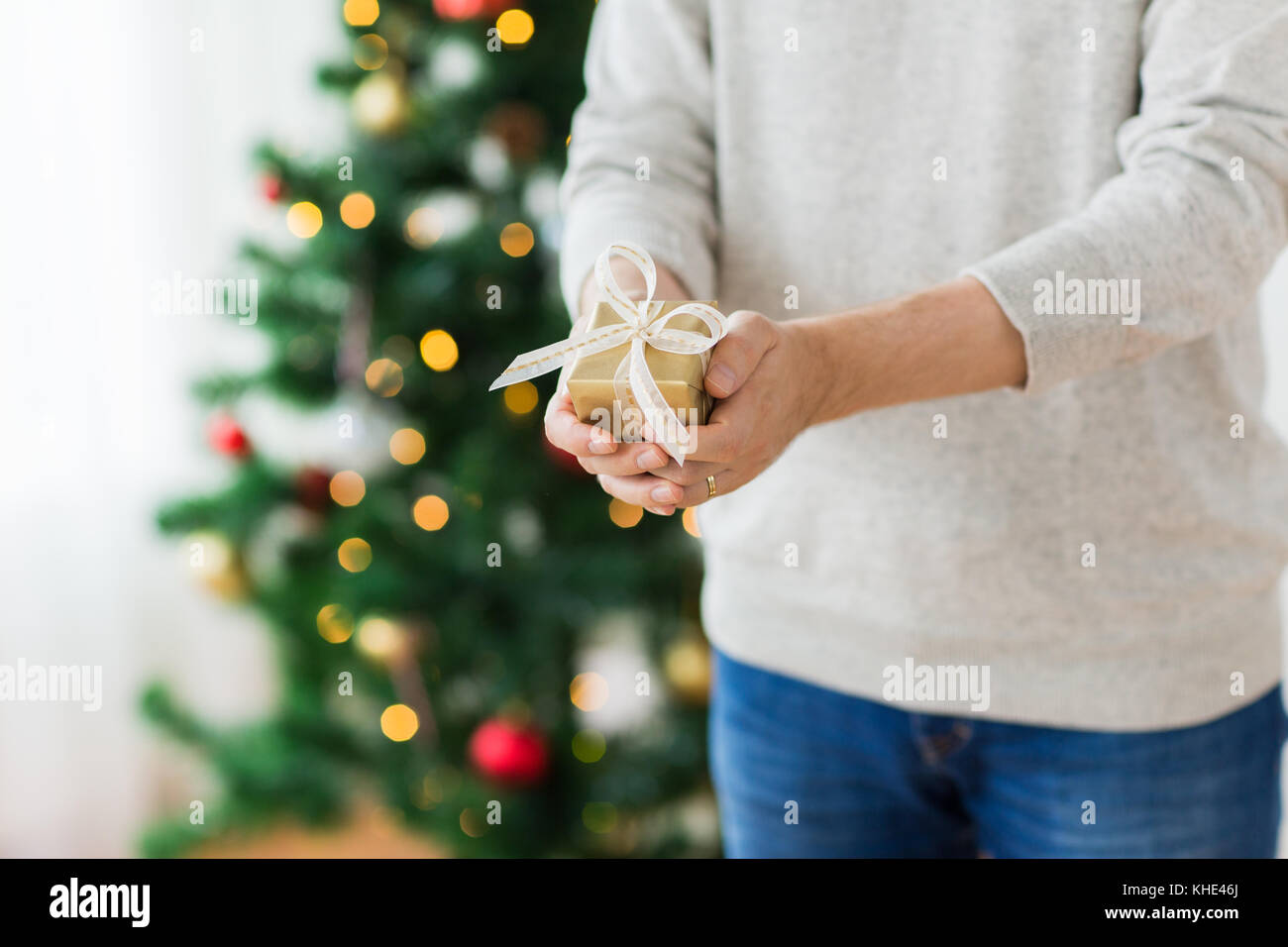 close up of man with christmas gift at home Stock Photo - Alamy