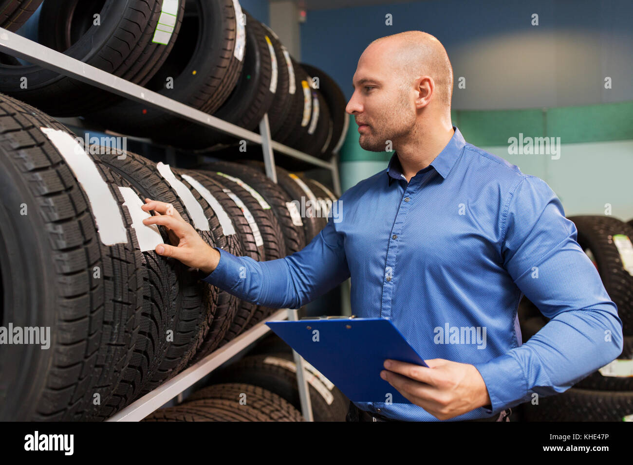 auto business owner and wheel tires at car service Stock Photo Alamy