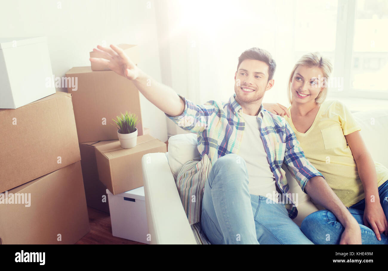 couple with boxes moving to new home and dreaming Stock Photo - Alamy