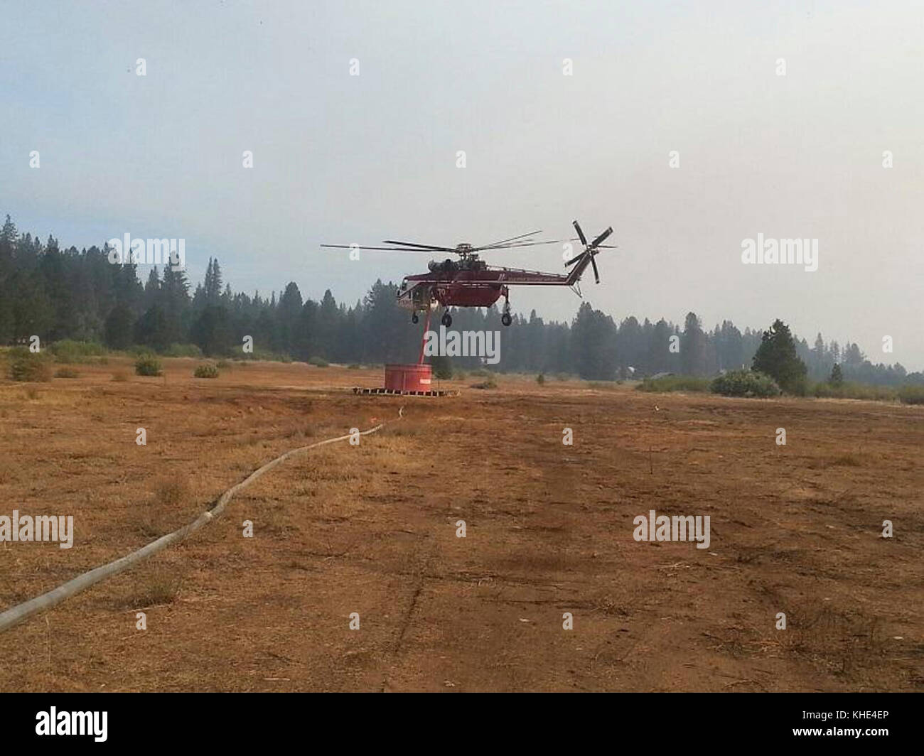 Helicopter fills water bucket at portable tank t use against the Pioneer Fire. The Pioneer Fire located in the Boise National Forest near Idaho City, ID began on Jul. 18, 2016 and the cause is under investigation.  The Pioneer Fire has consumed 96,469 acres. U.S. Forest Service photo. Stock Photo