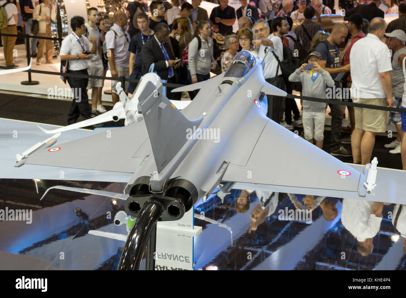 PARIS - FRANCE - JUN 23, 2017: Visitors watching the mock-up planes at a stand of the French aircraft manufacturer Dassault Aviation during the Paris  Stock Photo