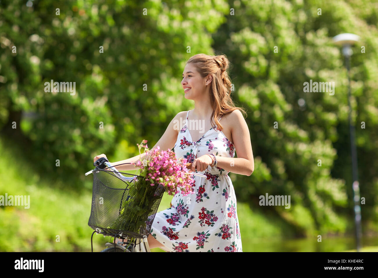 happy woman riding fixie bicycle in summer park Stock Photo