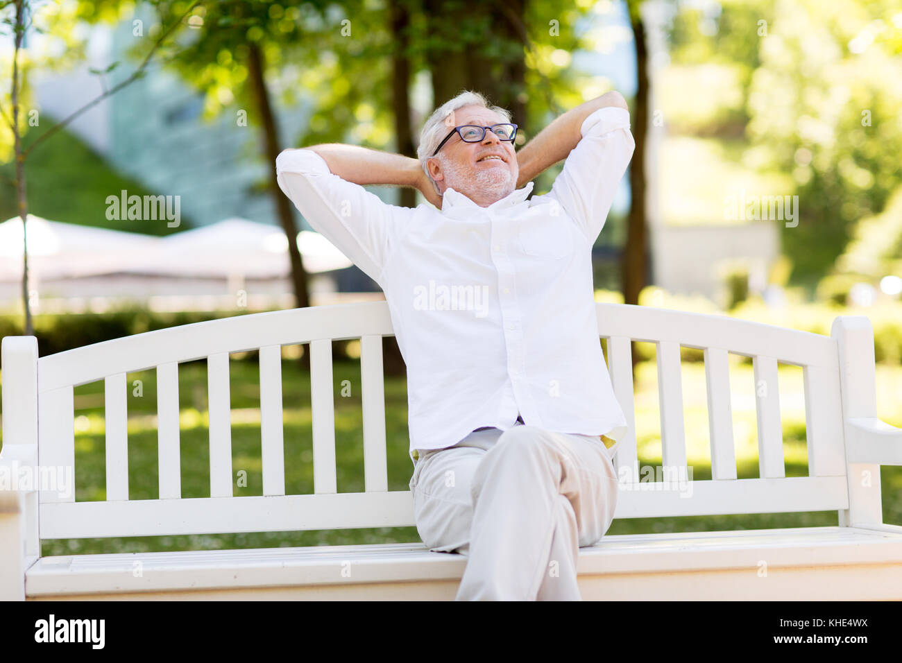 happy senior man sitting on bench at summer park Stock Photo - Alamy