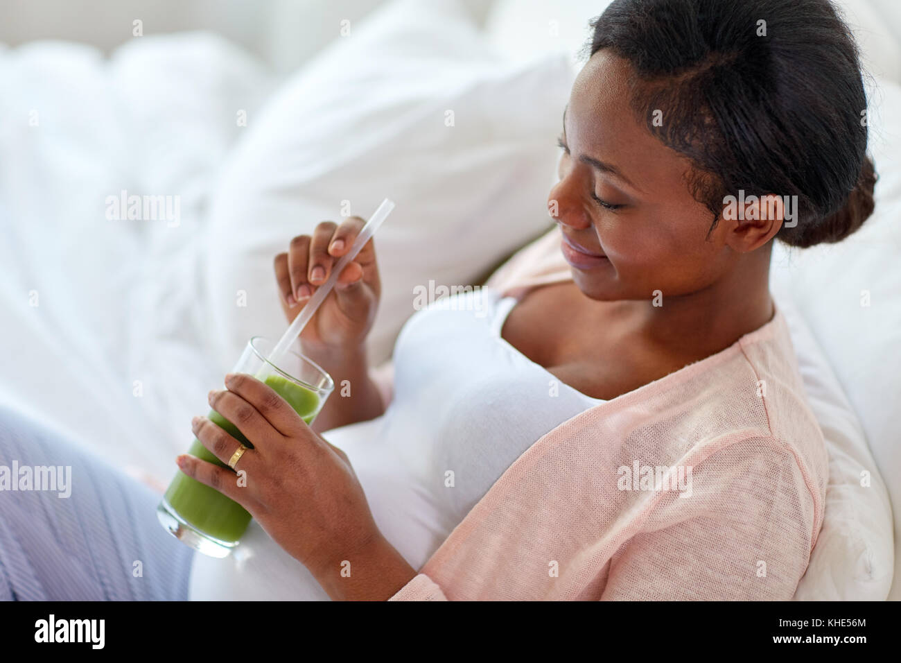 pregnant woman drinking vegetable juice in bed Stock Photo Alamy