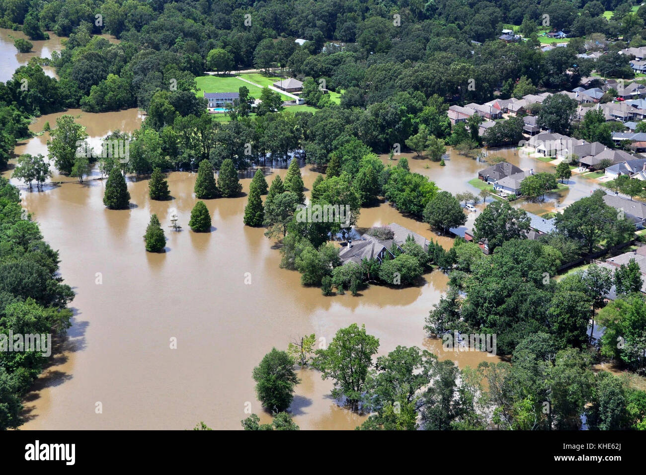 An aerial view taken from an MH-65 Dolphin helicopter shows severe flooding in a residential area of Baton Rouge, LA on Aug. 15, 2016. Coast Guard photo by Petty Officer 1st Class Melissa Leake. Stock Photo