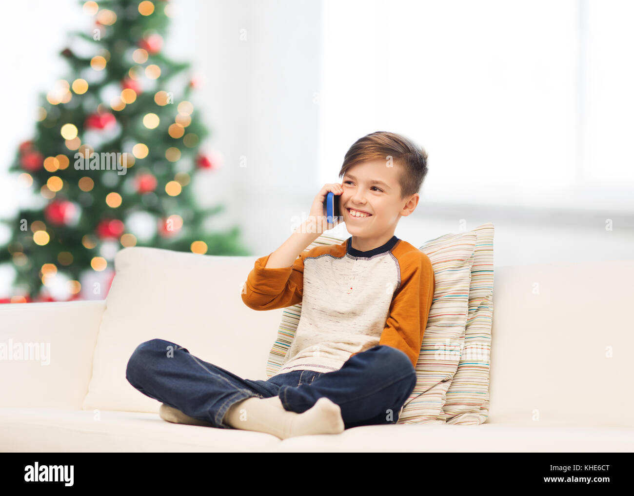 boy calling on smartphone at home at christmas Stock Photo