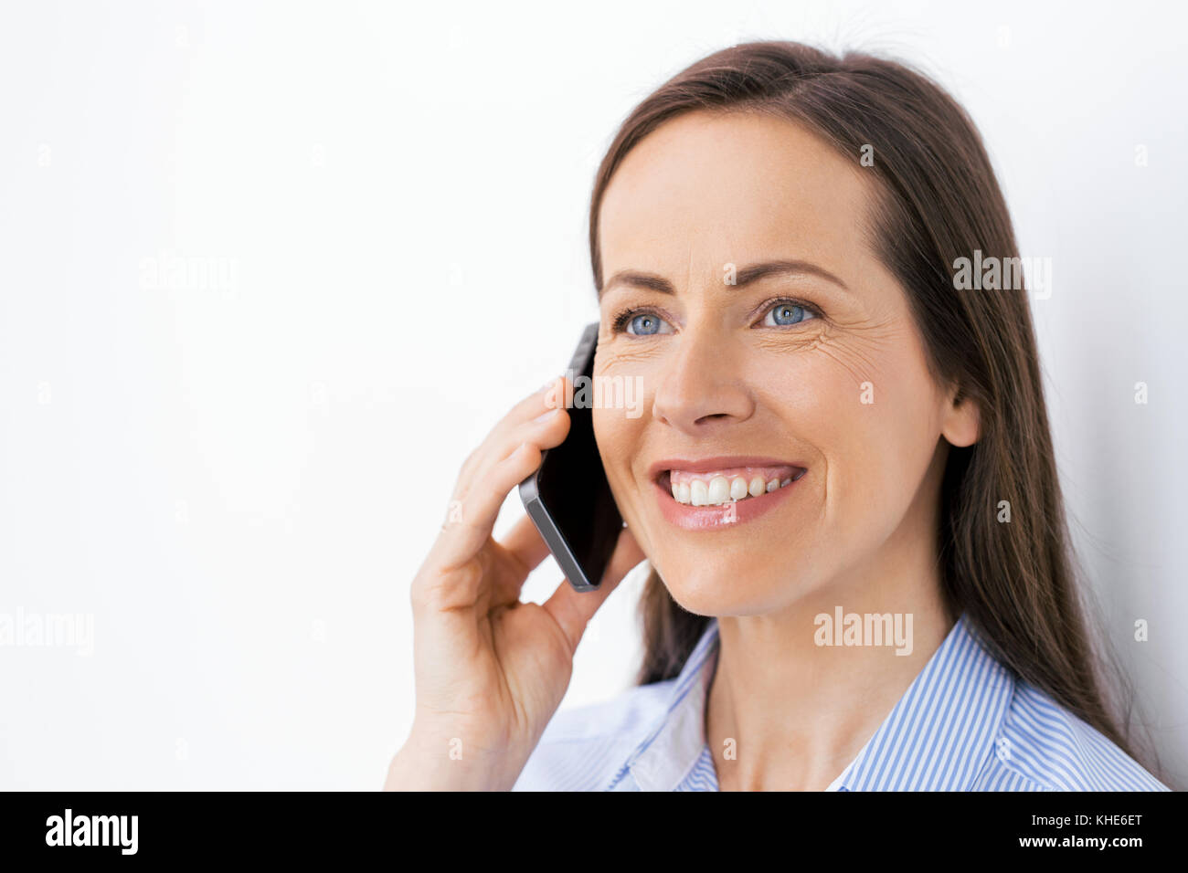 businesswoman calling on smartphone at office Stock Photo