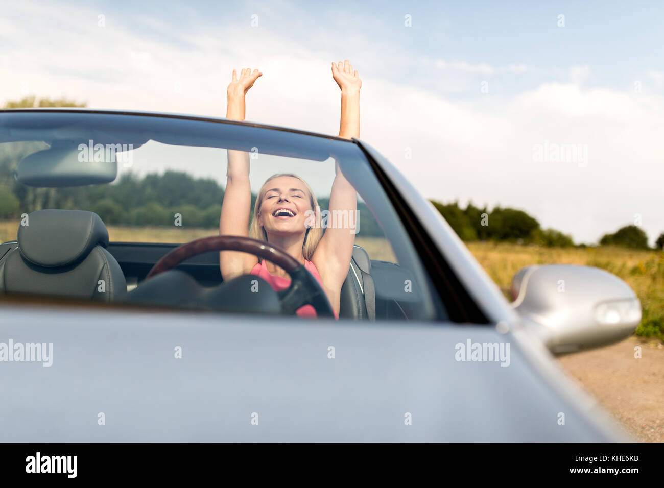 happy young woman in convertible car Stock Photo - Alamy