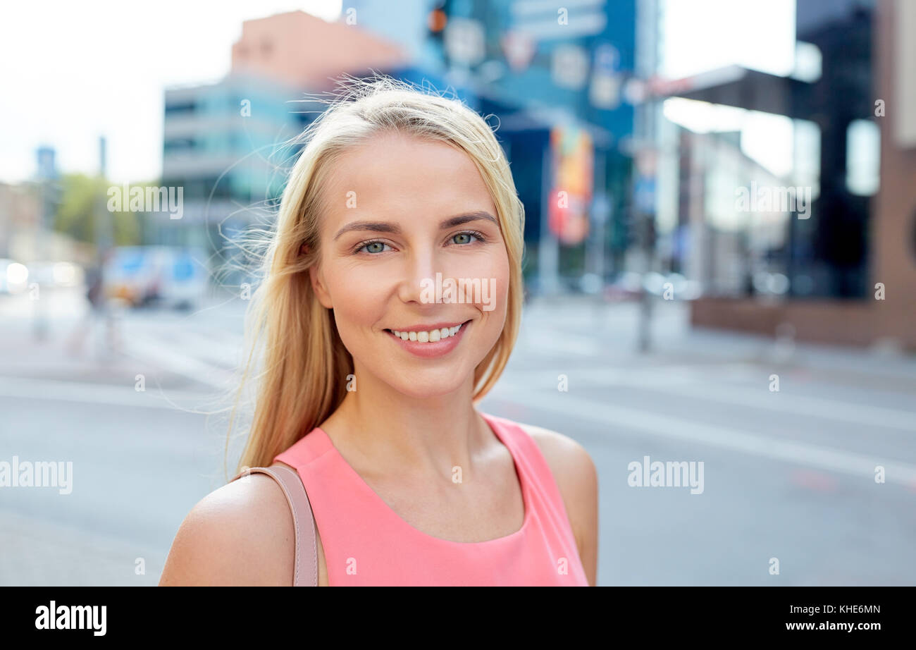 happy smiling young woman on city street Stock Photo - Alamy