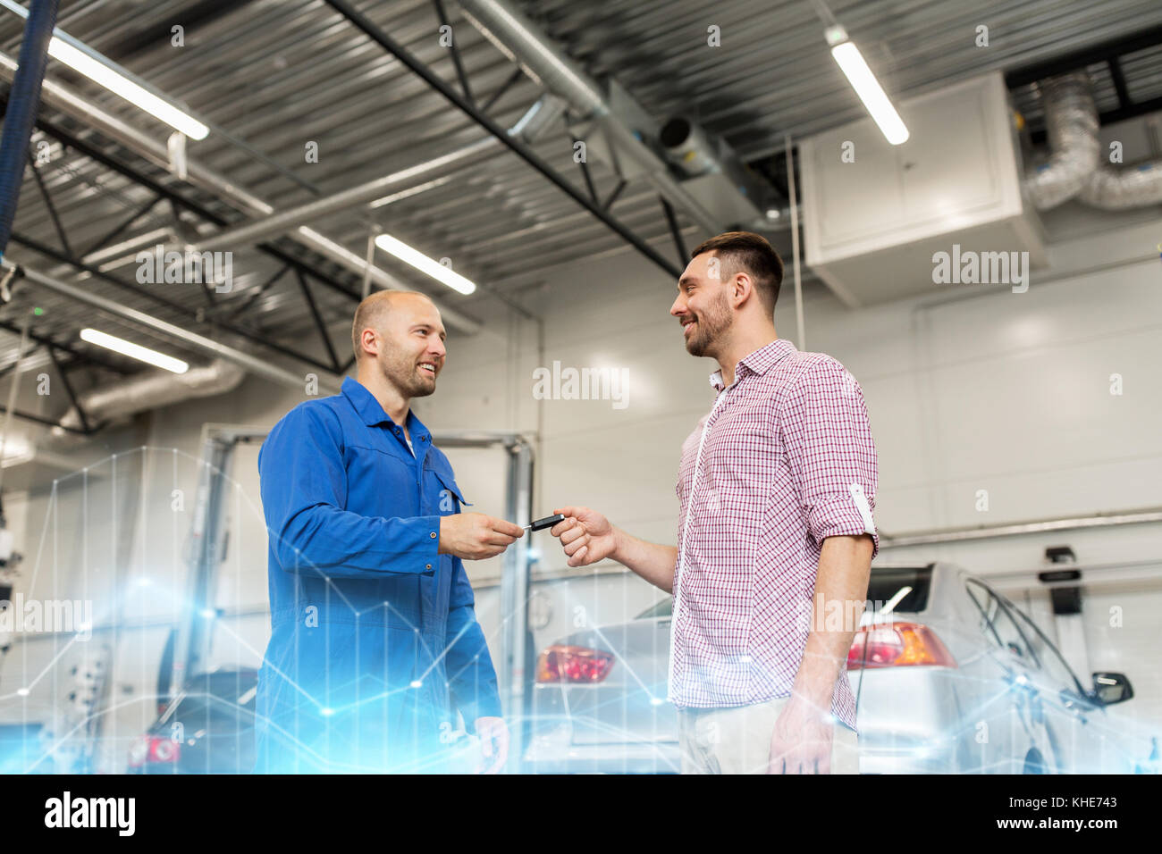 auto mechanic giving key to man at car shop Stock Photo - Alamy