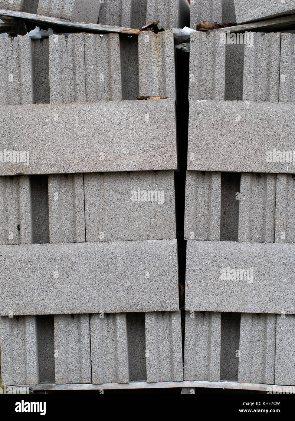 Cement blocks, breeze blocks, stacked. Building material, leaning precariously. Stock Photo