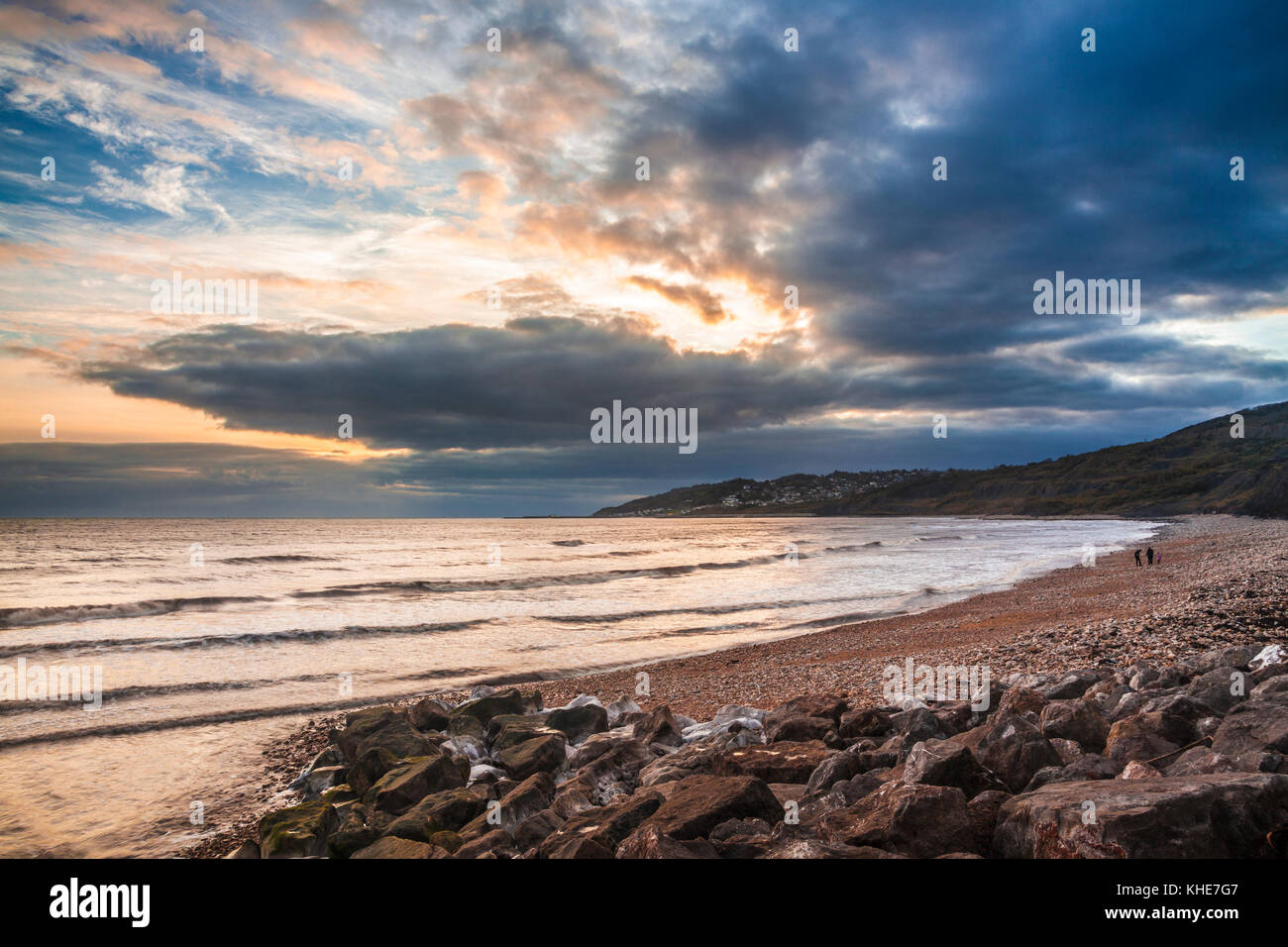 Sunset on Charmouth beach looking towards Lyme Regis. Stock Photo