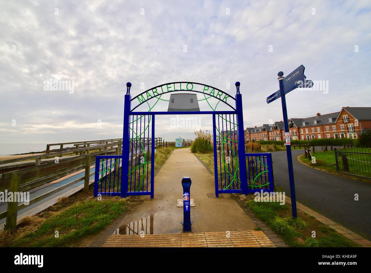 Blue metal entrance gate to Martello Park on the seafront in Felixstowe, Suffolk. Stock Photo