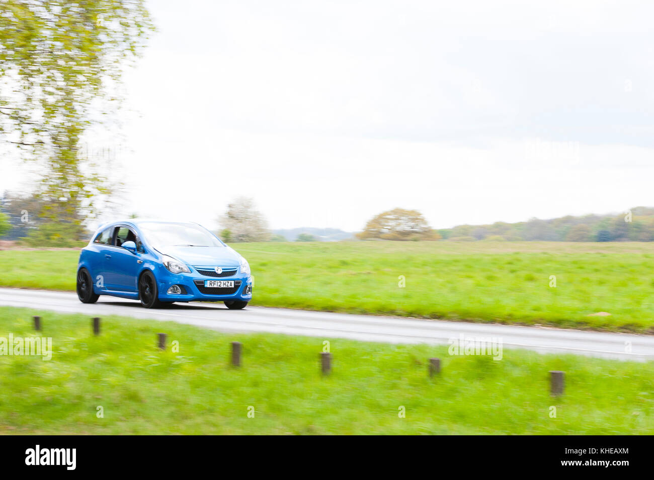 Hertfordshire, UK. A blue Vauxhall Astra drives along a narrow country road. Stock Photo