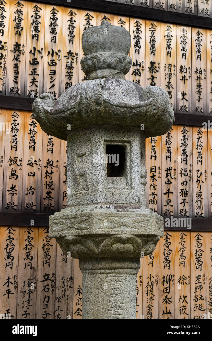Nara, Japan -  May 30, 2017: Stone lantern with Memorial donor plaques at the Kasuga Taisha Shrine in Nara, Japan Stock Photo