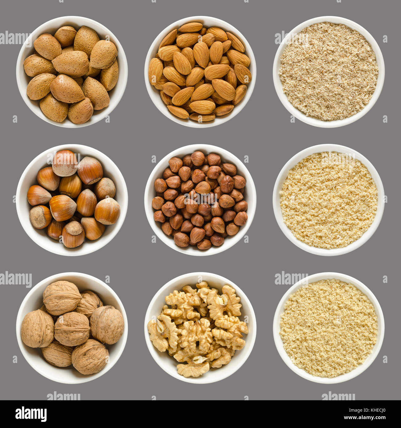 Almonds, hazelnuts and walnuts in bowls. Whole, shelled and grounded nuts in white china. Prunus