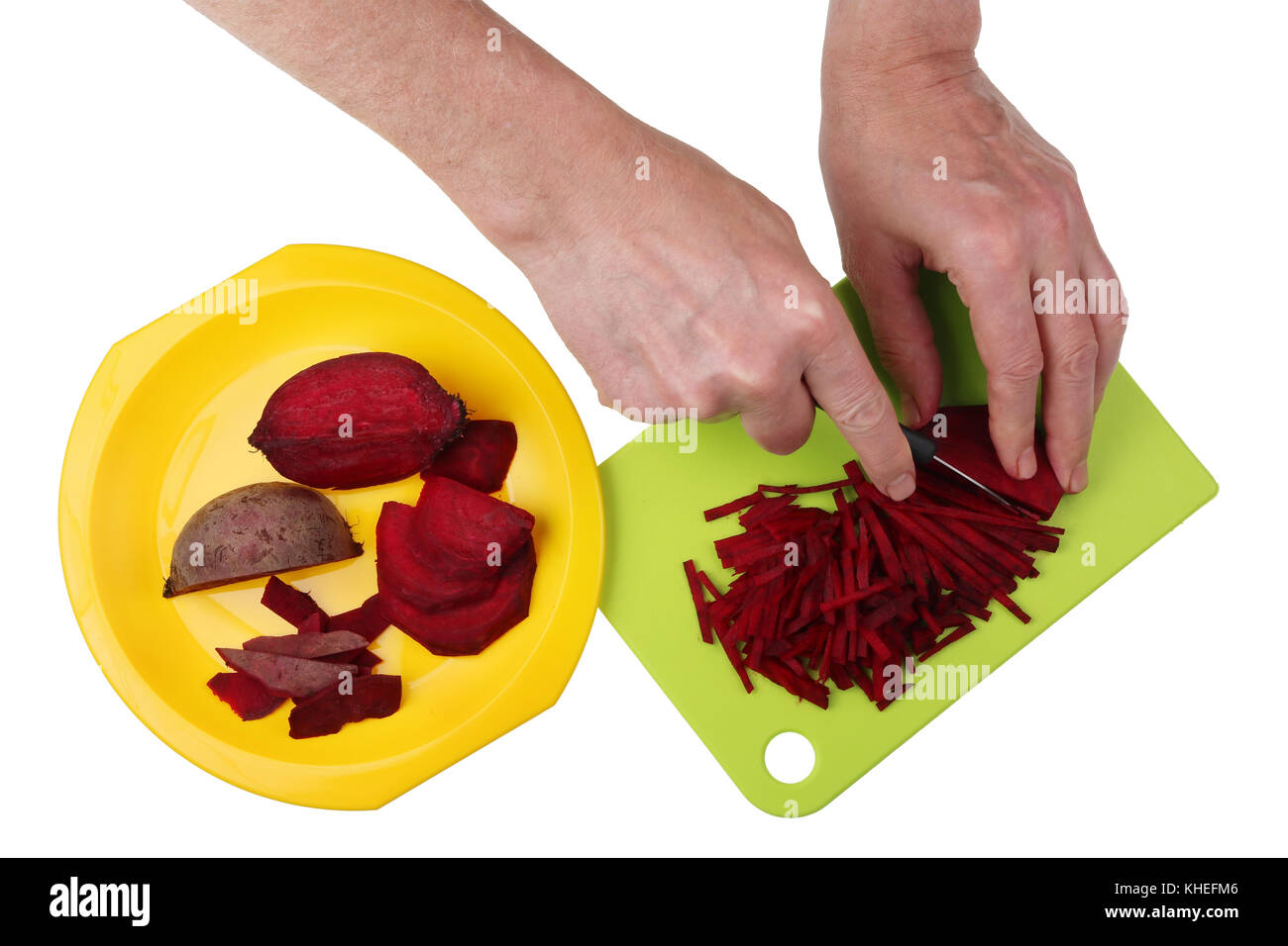 To cook a tasty vegetable soup beet  must be finely chopped into stripes with  hands and a sharp knife. Isolated on white top view studio shot Stock Photo