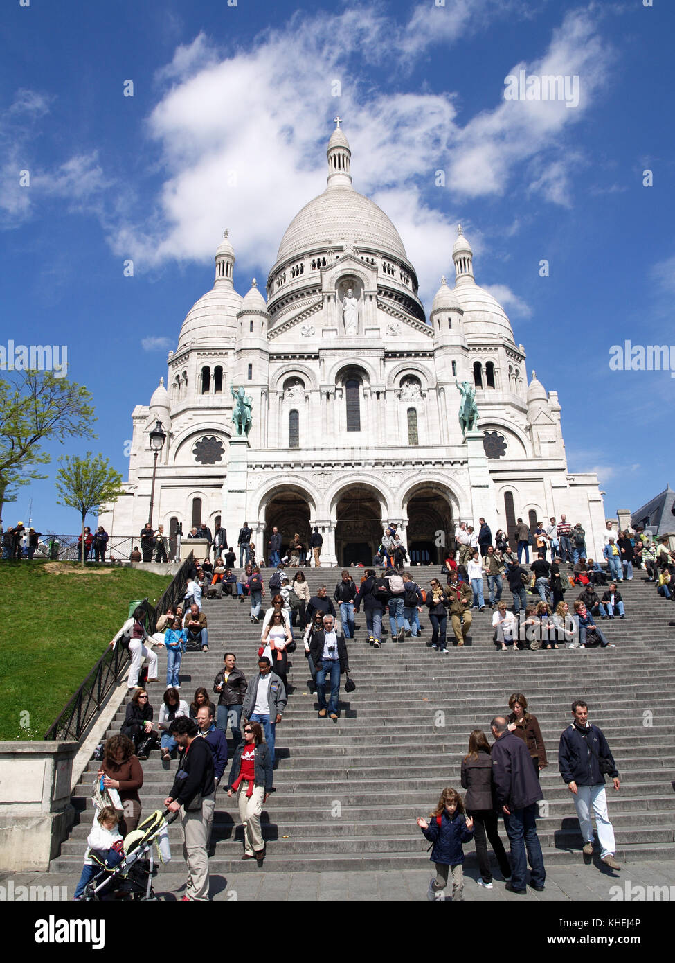 Tourists on steps at Basilica of the Sacred Heart of Paris, commonly