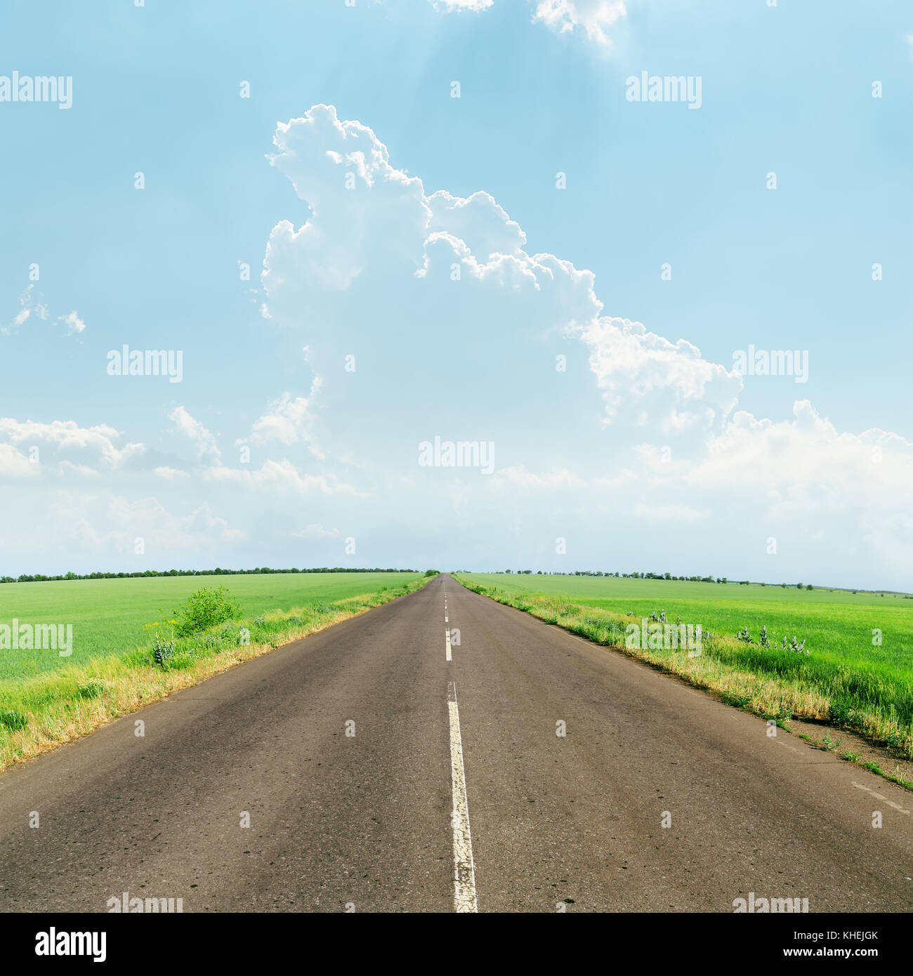 light clouds over asphalt road to horizon Stock Photo - Alamy