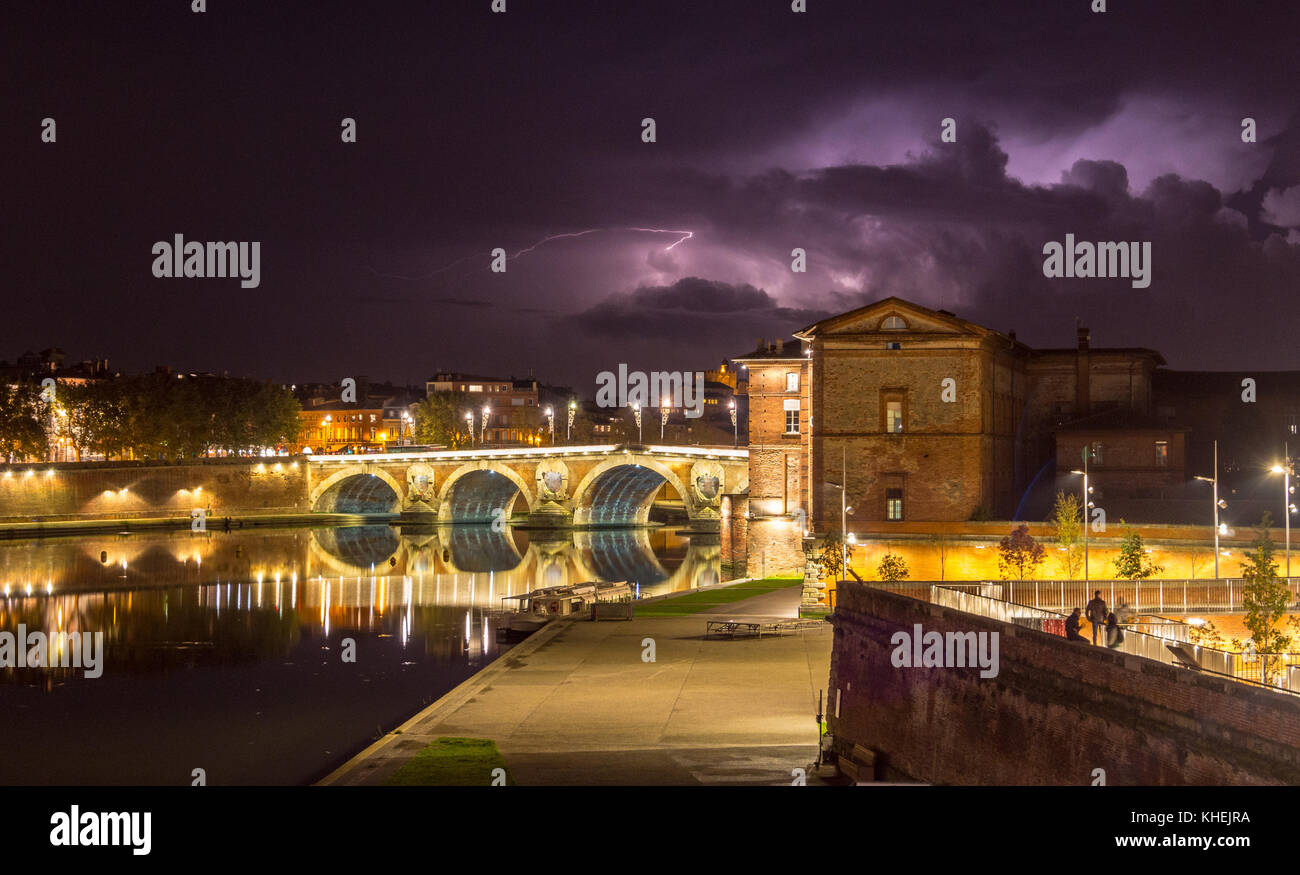 Lightning storm seen over Pont Neuf and Quai de la Daurade floodlit at night, Garonne river, St. Cyprien,Toulouse, Haute-Garonne, Occitanie, France Stock Photo