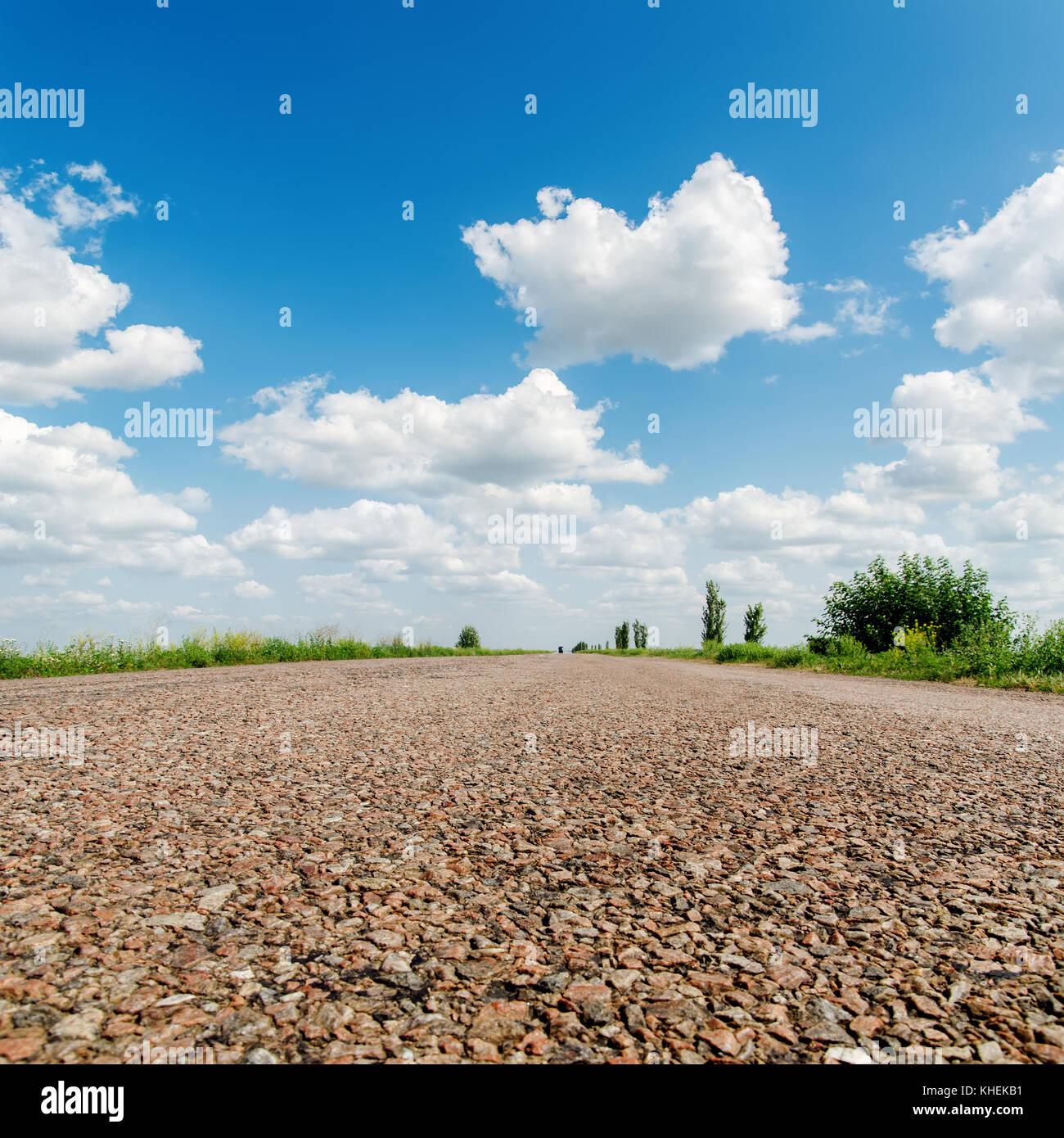 asphalt road closeup under clouds in sky Stock Photo - Alamy