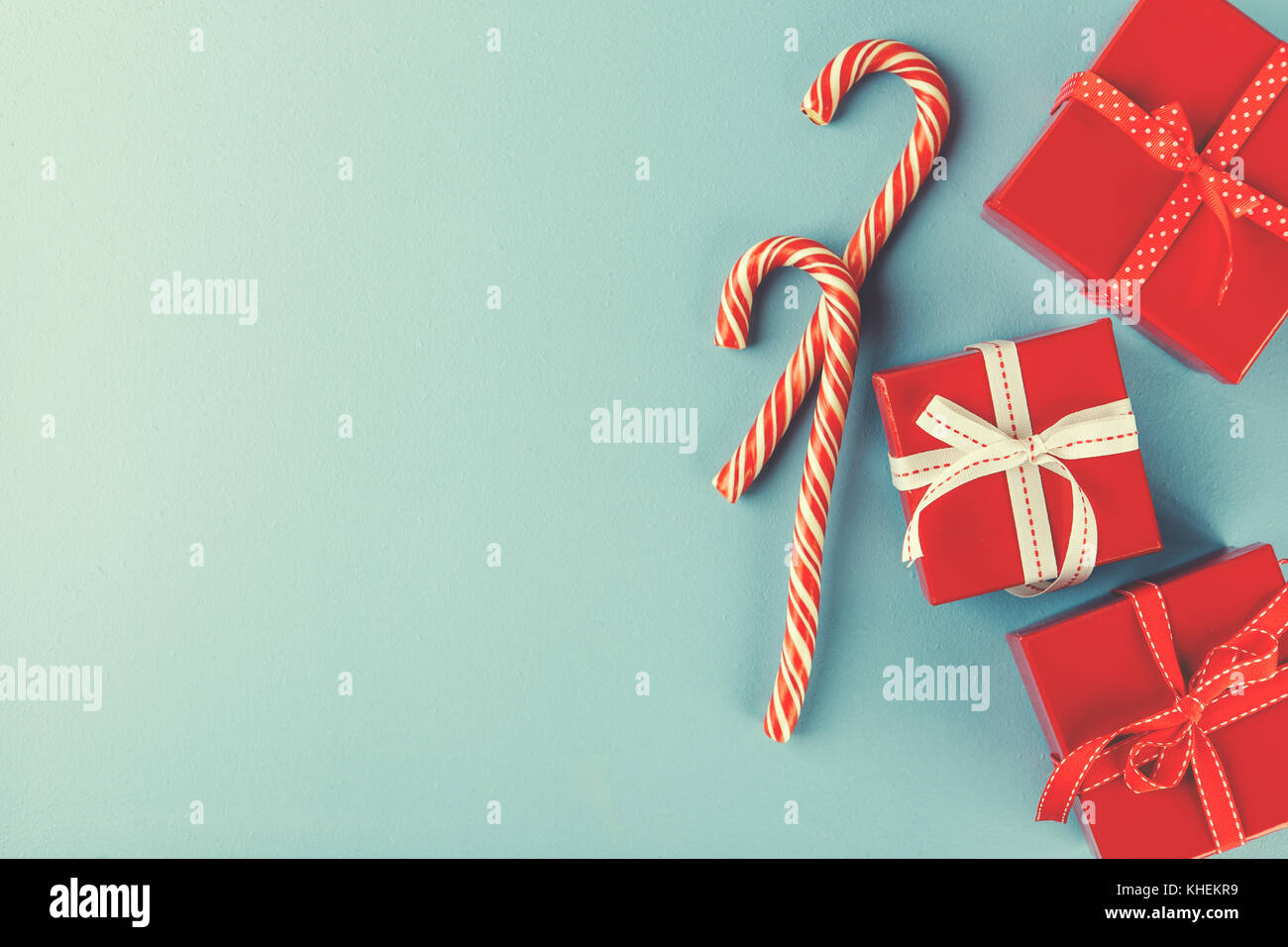 Christmas red gift boxes and Candy canes onblue background. Flat lay ...