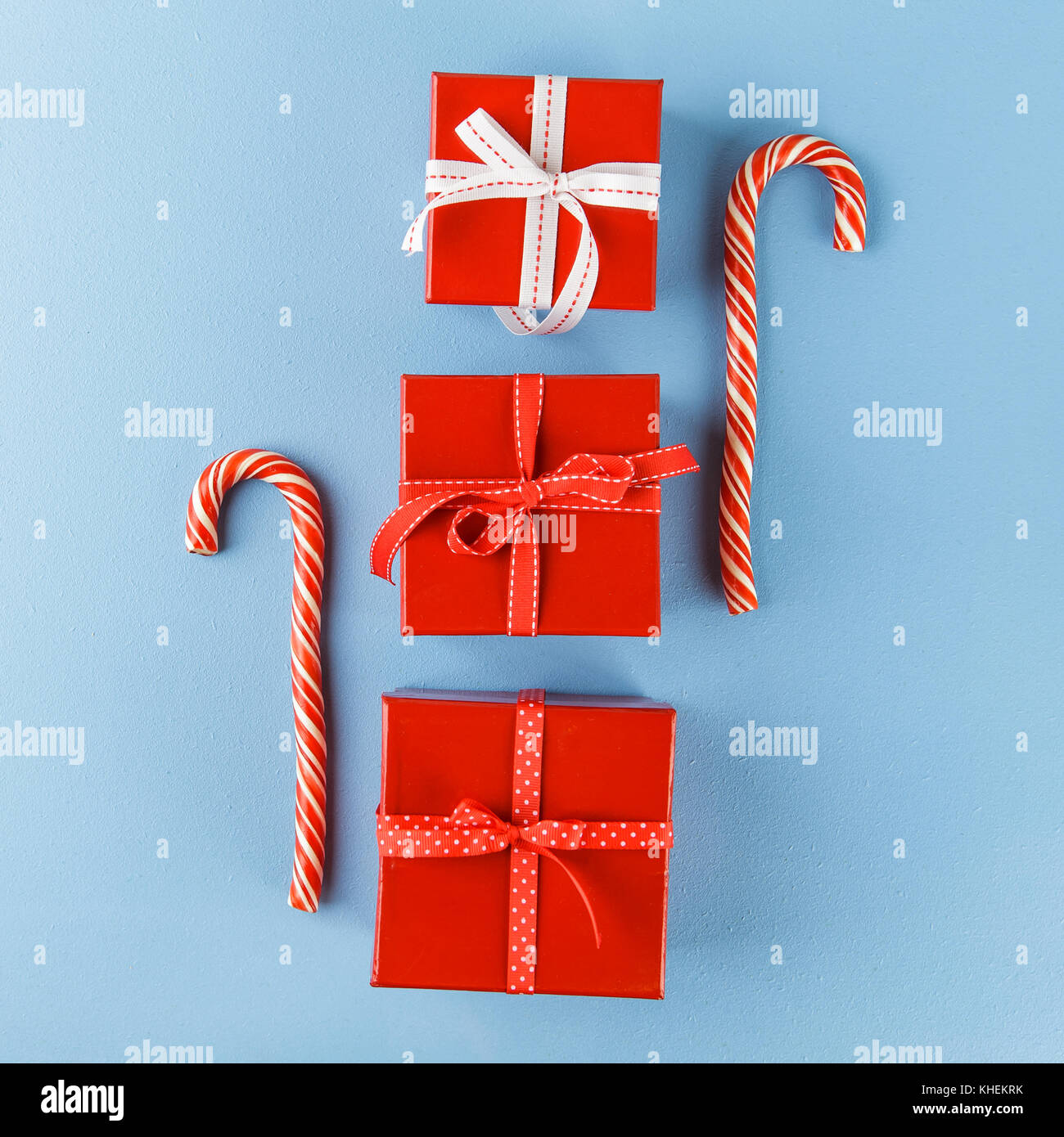 Christmas red gift boxes and Candy canes onblue background. Flat lay ...