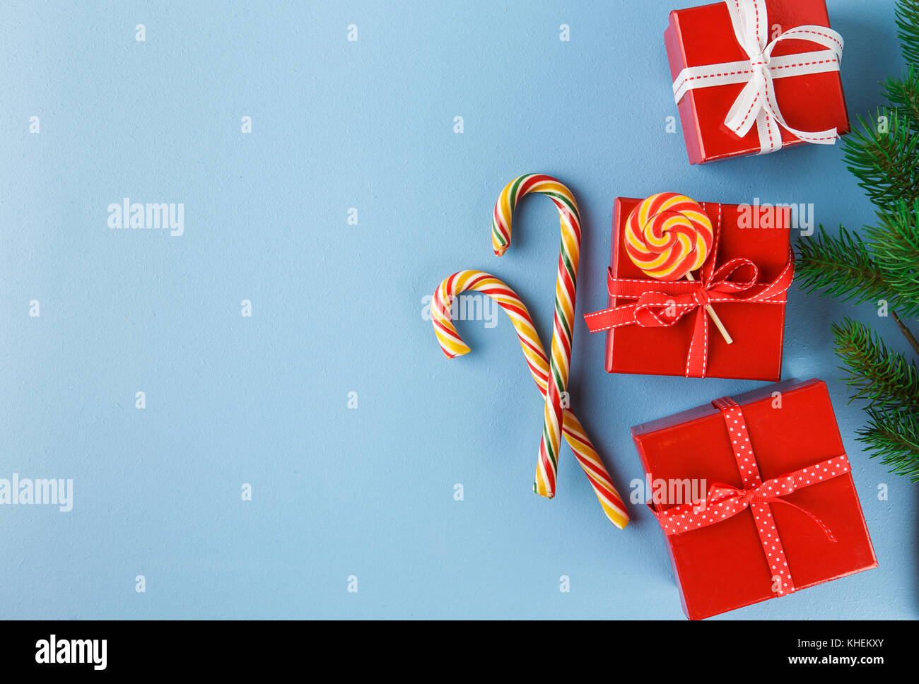 Christmas gift boxes, decorations, candy canes and fir tree branch on ...