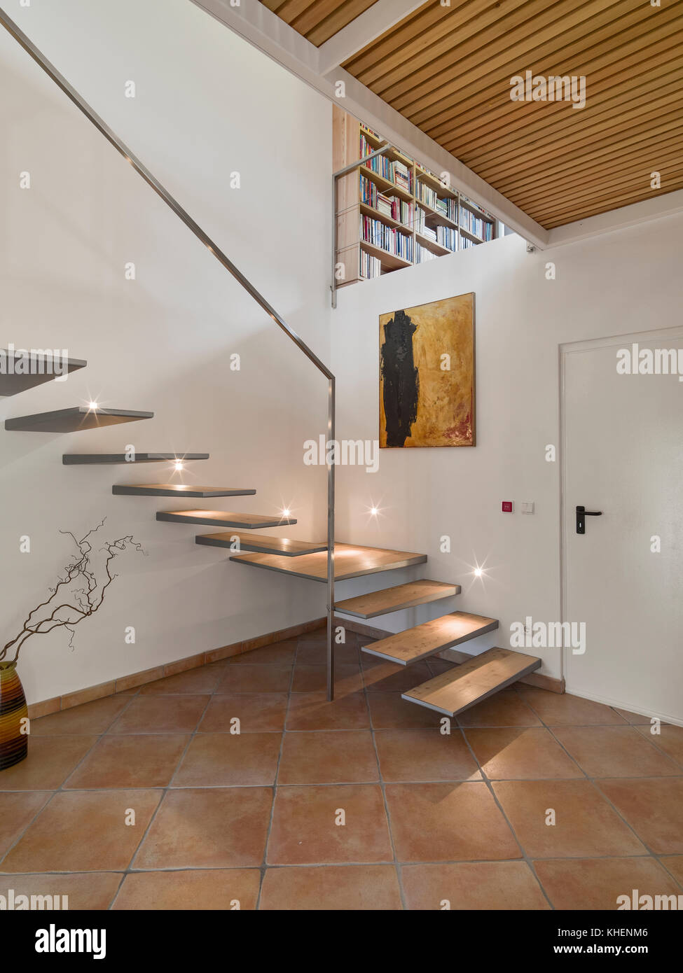 interiors shots of a modern entrance of a loft in the foreground the staircase the floor is made of wood Stock Photo