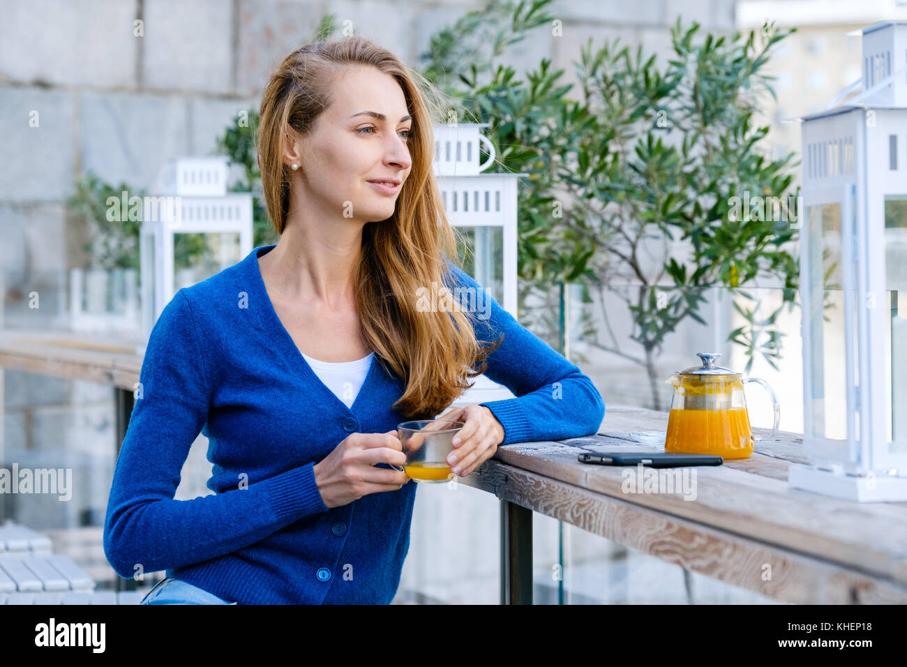 Young pretty woman enjoys cup of tea Stock Photo - Alamy