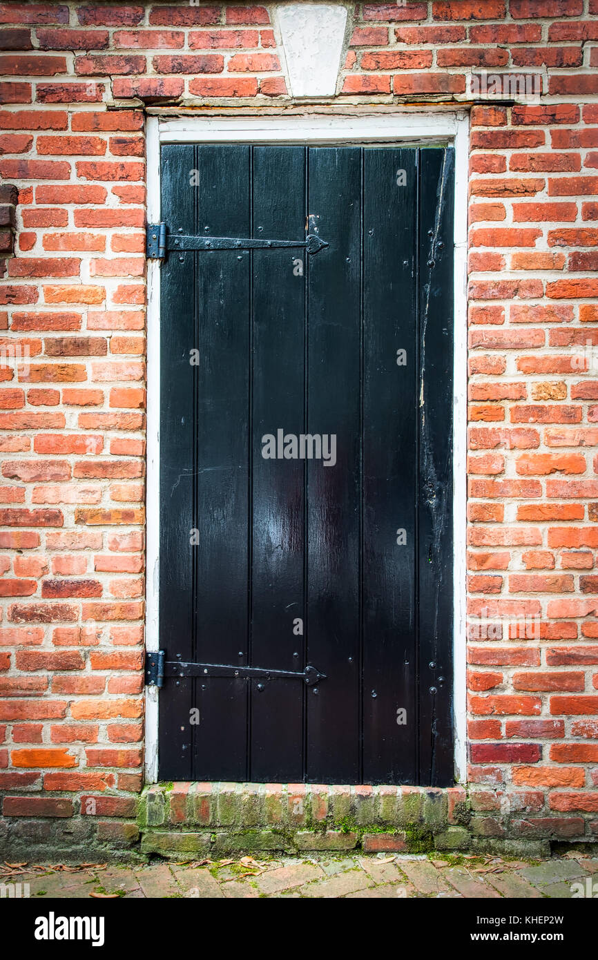 An old red brick wall and with a doorway in a northern Virginia city