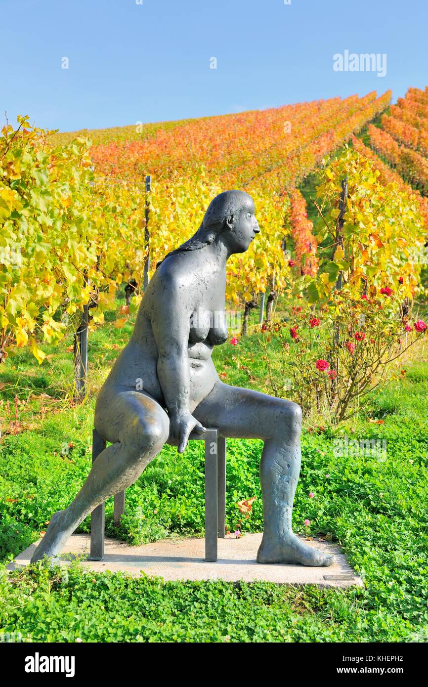 Seated bronze sculpture by Karl Ulrich Nuss in front of vineyards in autumn, sculpture path Strümpfelbach, Remstal Stock Photo