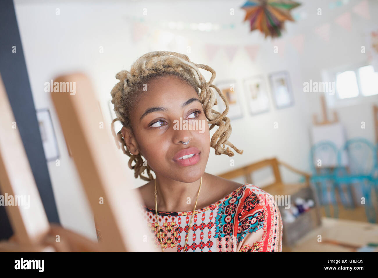A young woman in front of an easel Stock Photo - Alamy