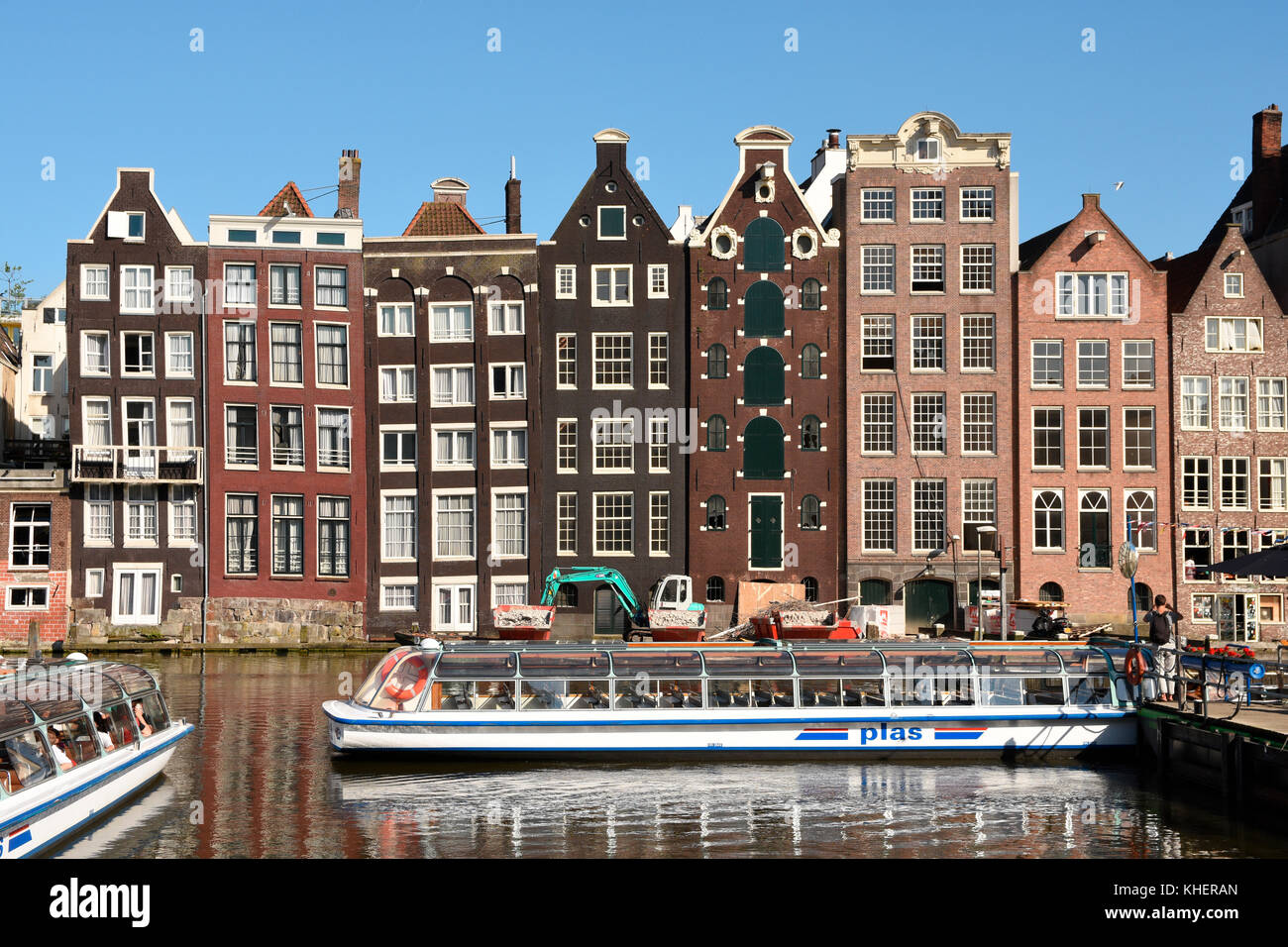 Historic buildings and boat for canal cruise on the Damrak, Amsterdam, North Holland, Holland, Netherlands Stock Photo