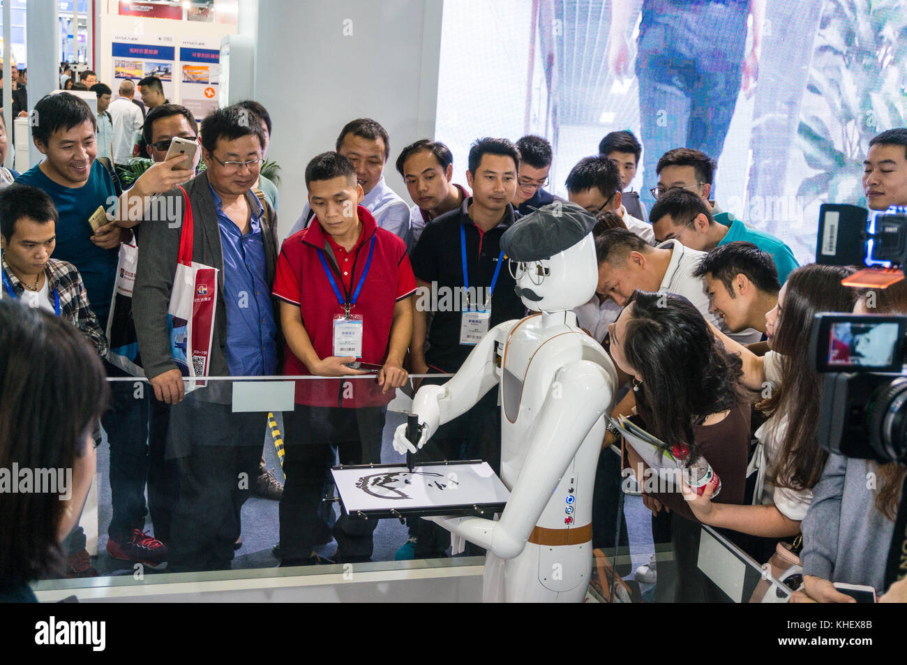 Intelligent AI drawing robot sketching pictures drawings likenesses of people through artificial intelligence at China hi-tech fair in Shenzhen, known as 'Silicon Valley of China', Shenzhen, China. Stock Photo