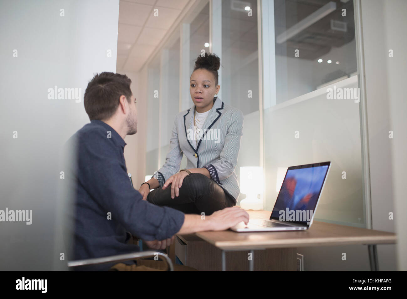 Young man and woman working in an an office Stock Photo - Alamy