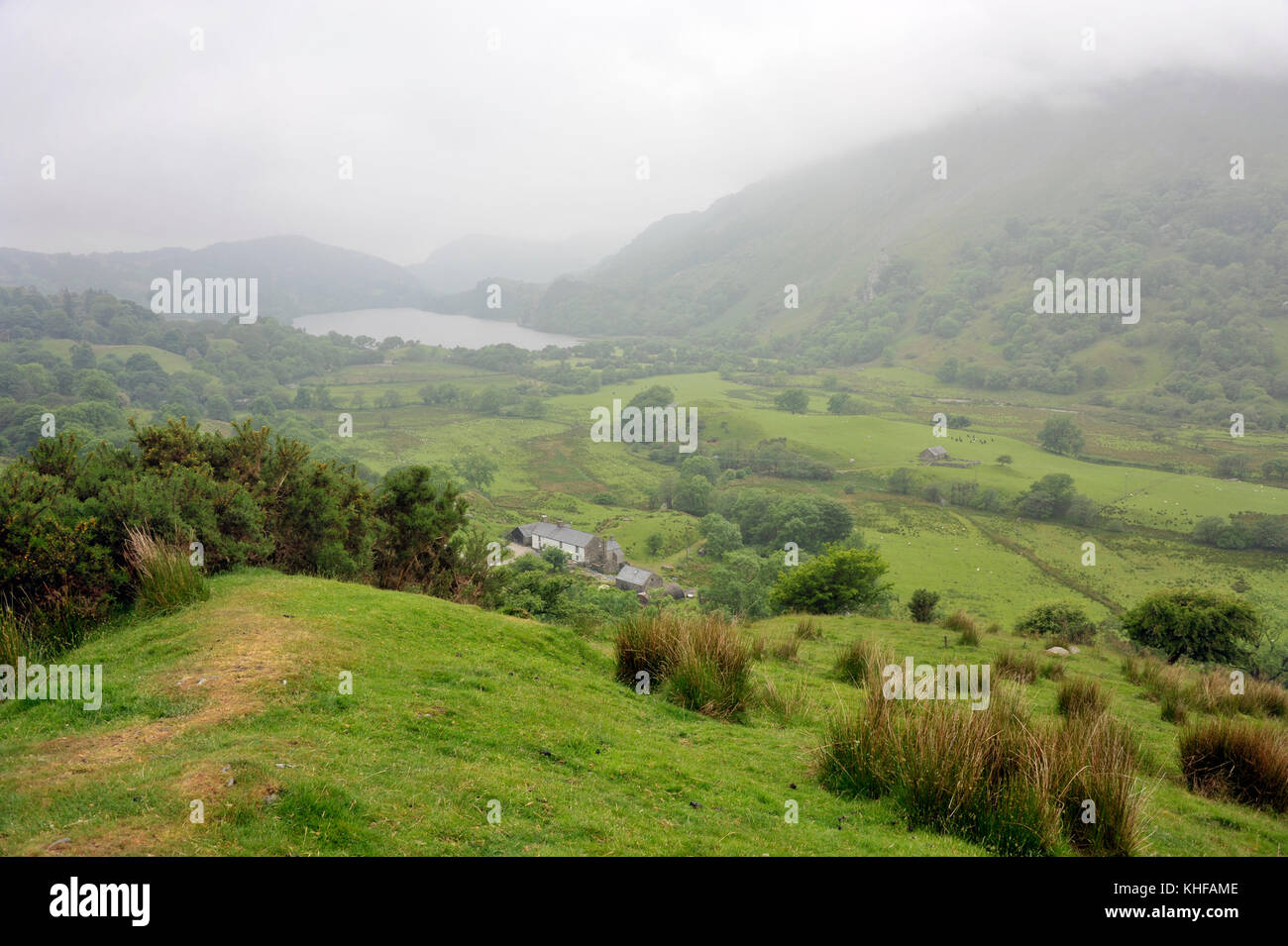 Misty morning looking south along Nant Gwynant Valley with the lake Llyn Gwynant, in the Snowdonia National Park, North Wales, UK. Stock Photo