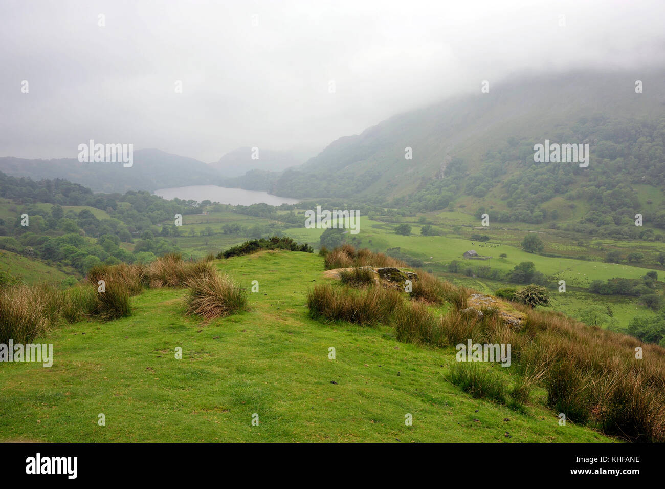 Misty morning looking south along Nant Gwynant Valley with the lake Llyn Gwynant, in the Snowdonia National Park, North Wales, UK. Stock Photo