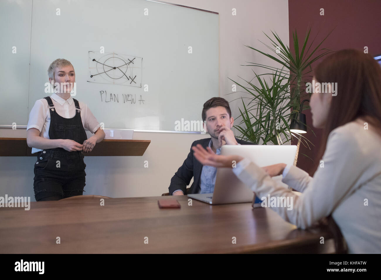 Youn professionals holding a meeting in coference room. Stock Photo