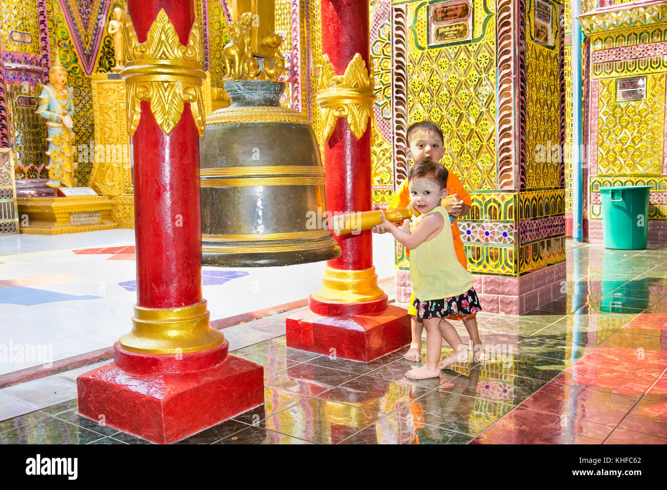 MANDALAY,MYANMAR - MARC 7, 2017: Myanmar children ringing the bell at  Su Taung Pyi Pagoda on top of Mandalay Hill on March 7, 2017, in Mandalay, Myan Stock Photo