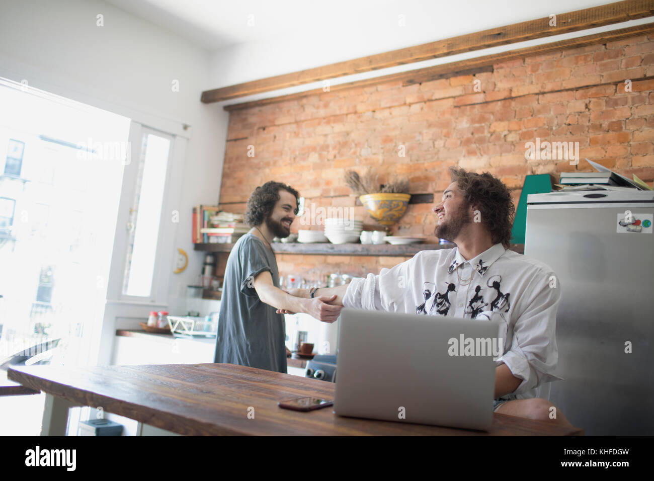 Gay couple in their kitchen Stock Photo