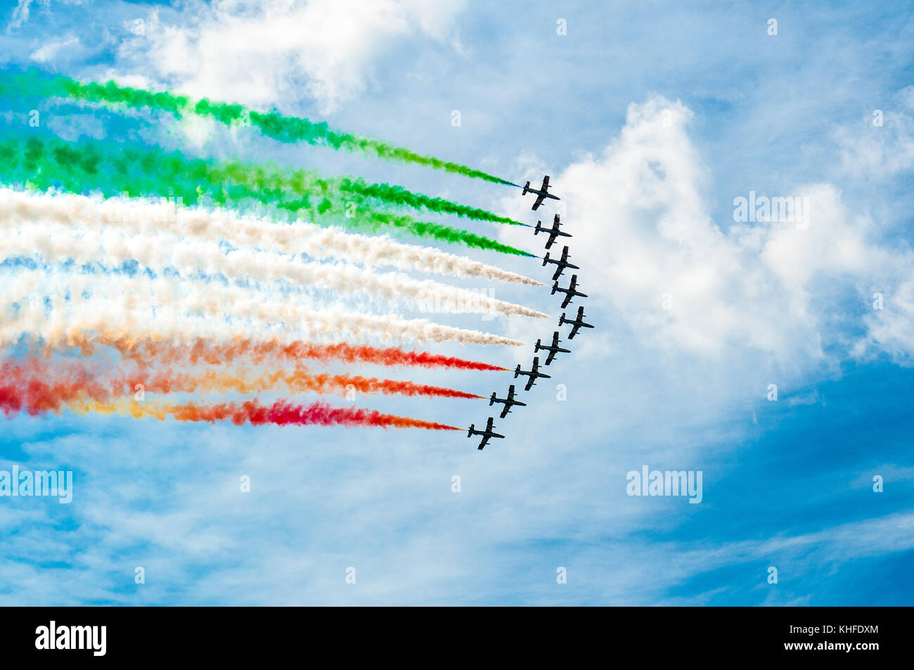 'freccie tricolori' acrobatic planes flight over sunny blue sky in summer dau making the italian flag in the sky Stock Photo