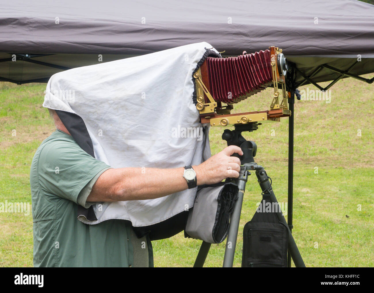 Photographer under the camera hood while taking photograph using a 4x5 view camera Stock Photo