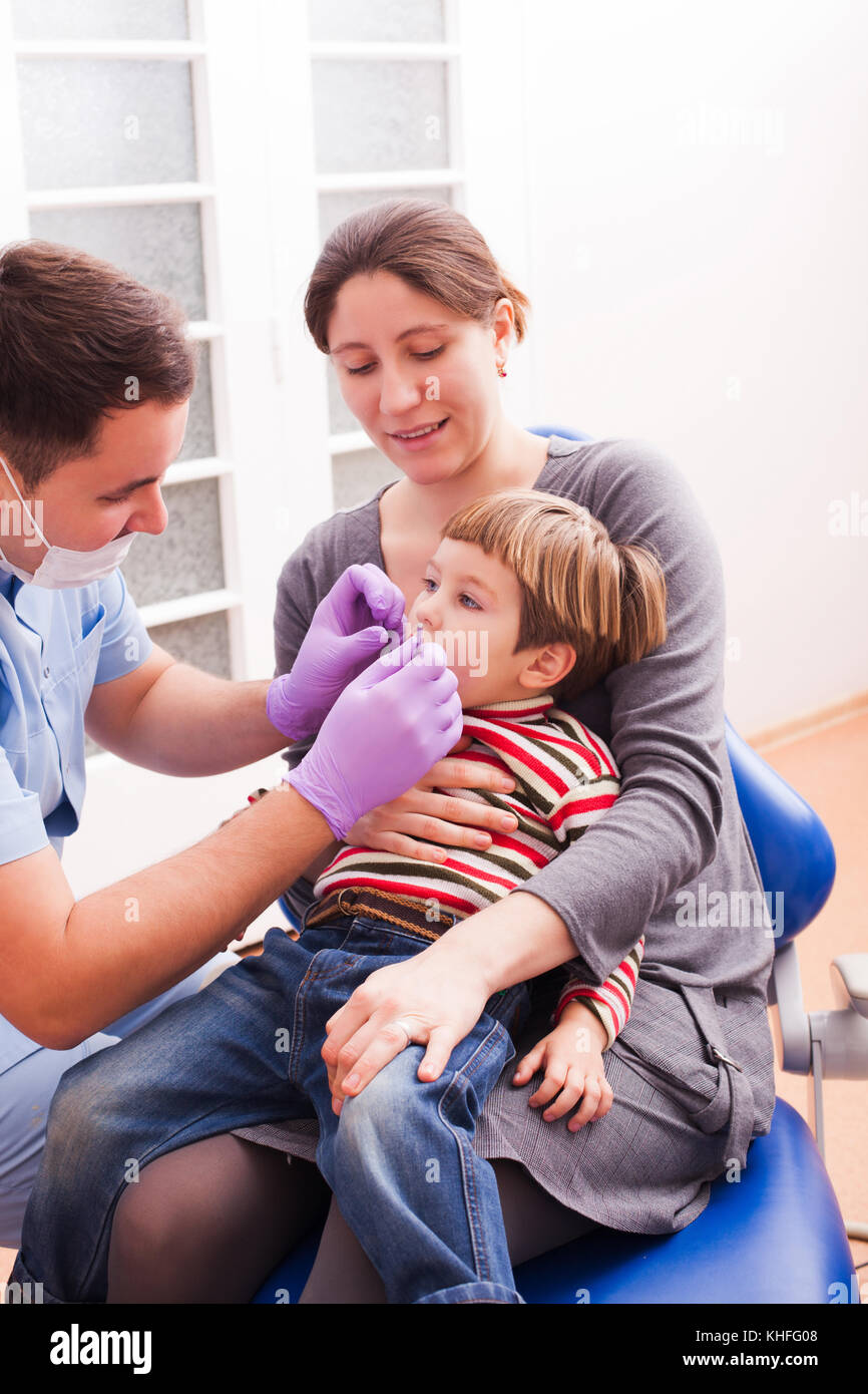 Mom and her little son visiting the dentist Stock Photo - Alamy