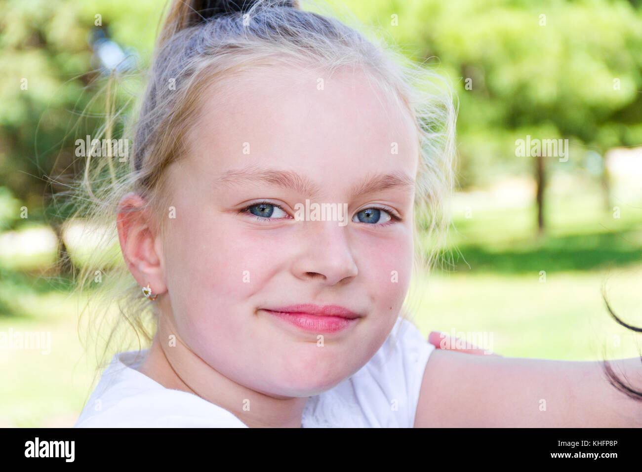 Cute girl with blond long hair and blue eyes Stock Photo - Alamy