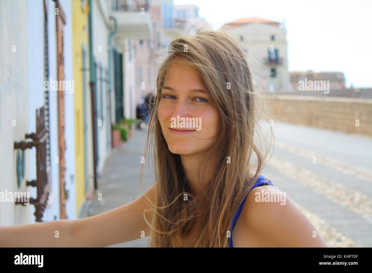 A young tourist woman poses for a personal picture on a vacation spot. Stock Photo