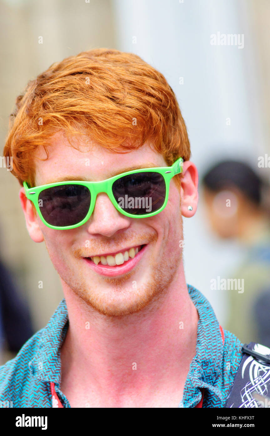 Male singer with red hair and wearing green sunglasses performing on the  Royal Mile during the Edinburgh International Fringe Festival Stock Photo -  Alamy