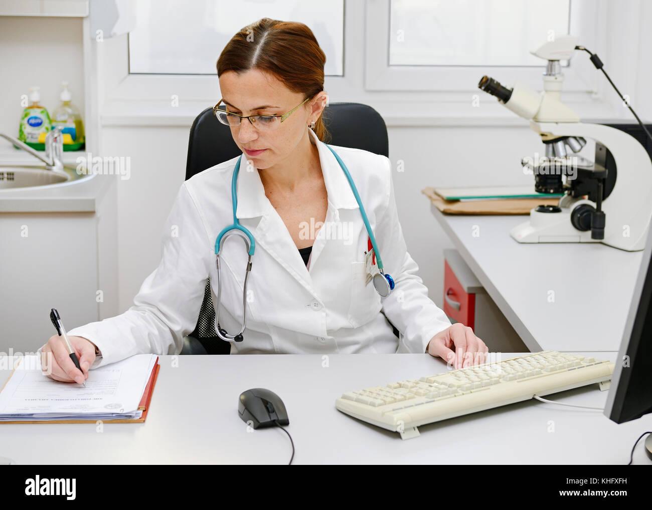 Doctor Working at Her Desk Stock Photo