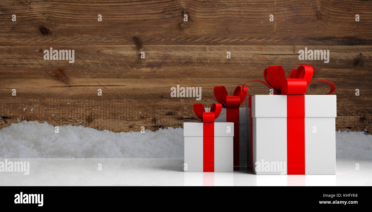 White gift boxes with red ribbons on wooden snowy background, copy ...