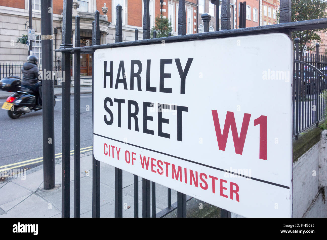 A man on a scooter passing Harley Street in the City of Westminster, London, UK Stock Photo